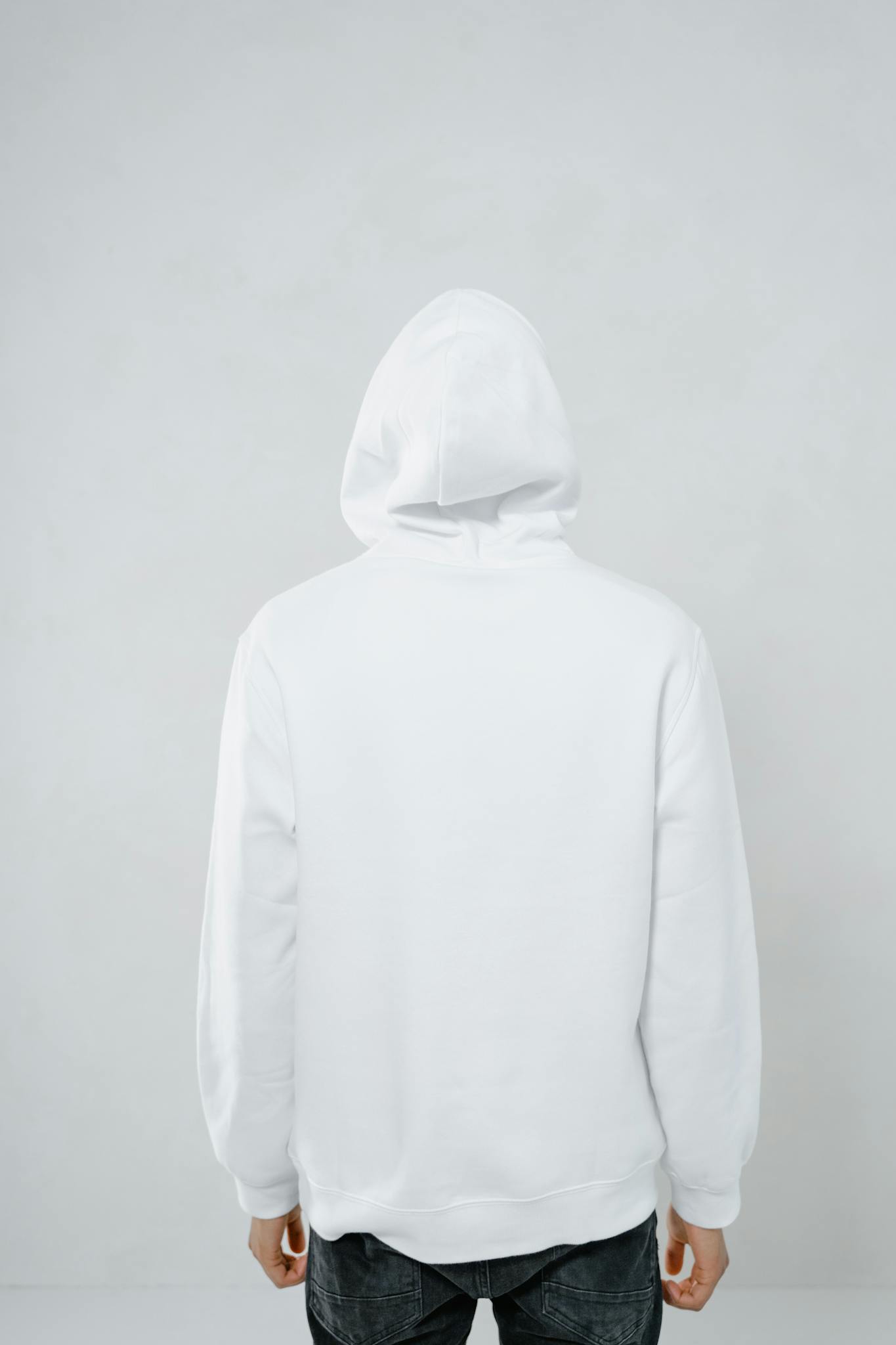 Minimalist back view of a person wearing a white hoodie, ideal for mockup purposes.